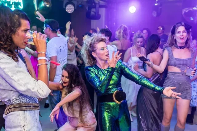 Fiesta corporativa temática 80s con disfraces y baile en Barcelona
