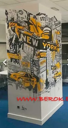Graffiti urbano en columna con temática New York, taxi amarillo y Estatua de la Libertad