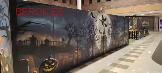 Graffiti mural de Halloween con laberinto, bruja y calabazas en centro comercial de Bilbao, arte urbano profesional en el País Vasco.