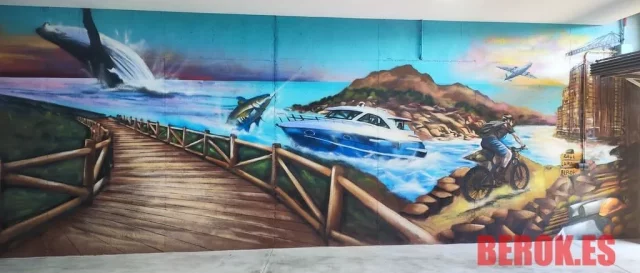 Graffiti de paisaje con mar barco y puente en parking Graffiti paisaje con mar barco puente y montañas en parking interior Port de la Selva