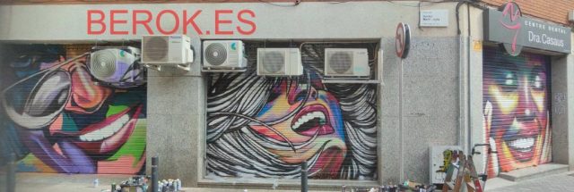Graffiti en persianas metálicas del Centre Dental Dra. Casaus con retratos pop art y arte urbano en El Prat de Llobregat.