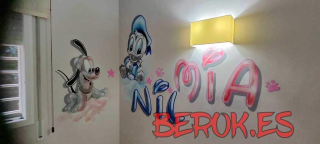 Mural infantil con Pluto, Pato Donald y nombres Mia y Nil pintado en habitación infantil.