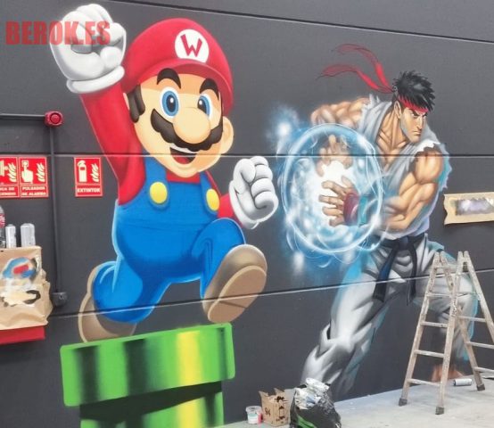 Graffiti con Mario Bros saltando y Ryu lanzando un ataque de energía.
