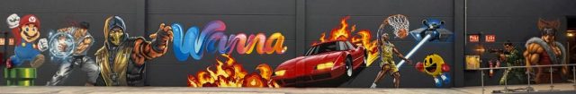 Gran mural de videojuegos arcade con Mario Bros, Ryu, Scorpion, Pac-Man, Kobe Bryant, un coche deportivo y guerreros.